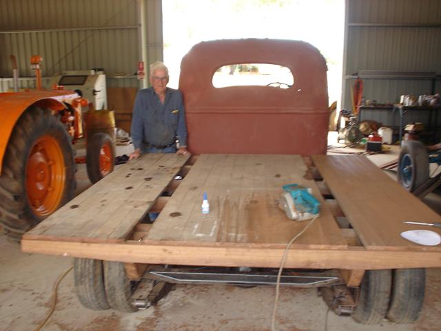 Base of wooden tray being adjusted during International Truck restoration